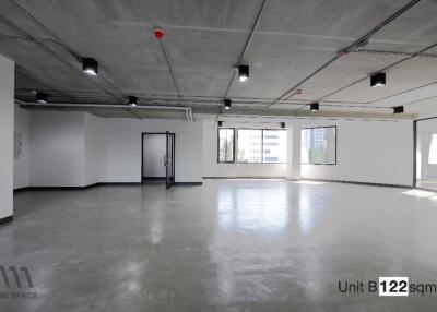 Spacious empty office space with large windows