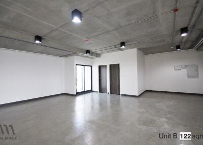 open space unit with concrete floors and ceiling