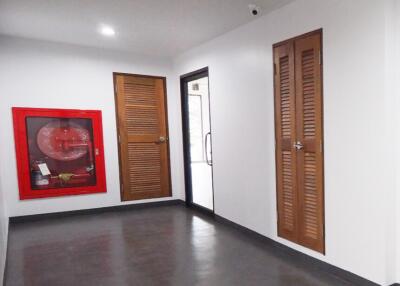 Hallway with wooden doors and fire extinguisher