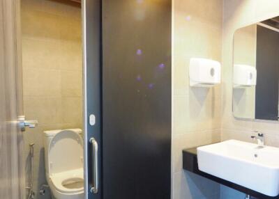 Modern bathroom with sliding door and wooden ceiling