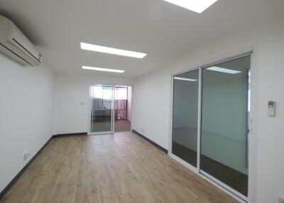 Spacious living room with wooden flooring and glass sliding doors