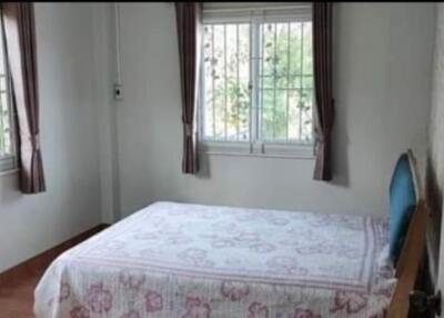 Well-lit bedroom with large windows and a double bed