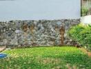 Backyard with grass and stone wall