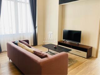 Living room with sofa, TV, and coffee table