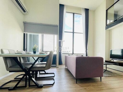 Modern living room with dining area and large window