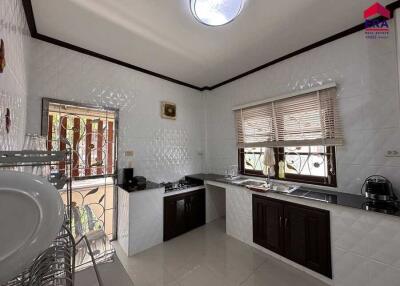 Modern kitchen with white tiles and natural light