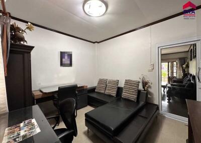 Living room with black sofa and desk