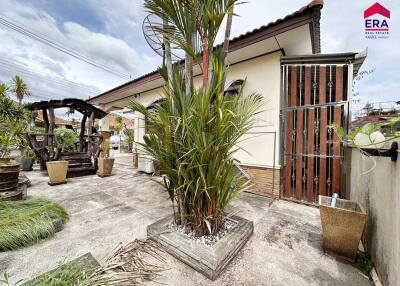 Outdoor garden area with plants and a seating gazebo