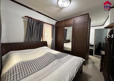 Bedroom with wooden furniture and large wardrobe