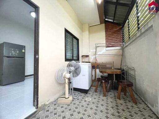 Utility room with appliances and small dining area