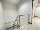 Modern indoor staircase with metal railing