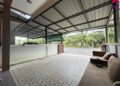 Covered outdoor area with seating and driveway