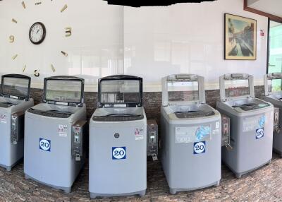 A well-maintained laundry room with multiple washing machines