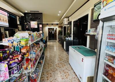 Interior view of a store with shelves of products and a freezer