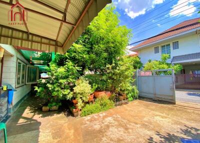 Front yard with trees and a garage