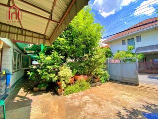 Front yard with trees and a garage