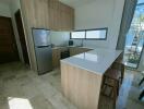 Modern kitchen with wooden cabinets and stainless steel appliances