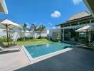 Modern backyard with a swimming pool and lounge chairs