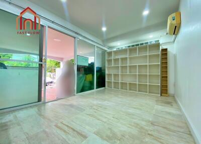 Spacious living room with large windows and built-in shelves