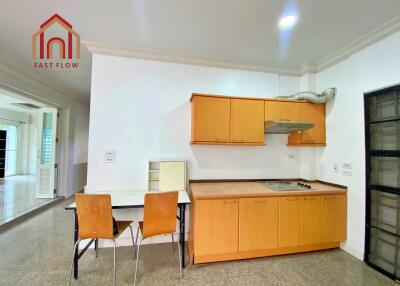 Simple modern kitchen with wooden cabinets and integrated dining area