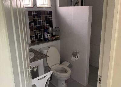 Clean and functional bathroom with toilet and sink