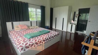 Spacious bedroom with large bed and wardrobe