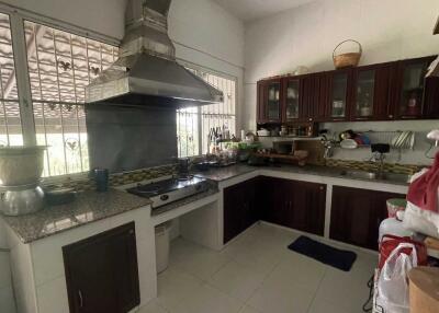 Modern kitchen with stainless steel appliances and dark wood cabinets