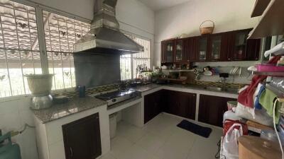 Modern kitchen with stainless steel appliances and dark wood cabinets