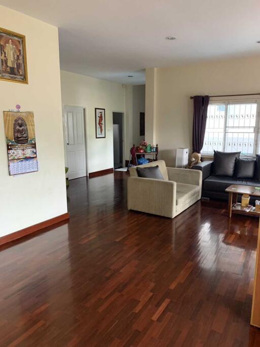 Spacious living room with wooden flooring and modern furniture