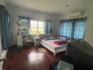 Cozy bedroom with wooden flooring and blue curtains