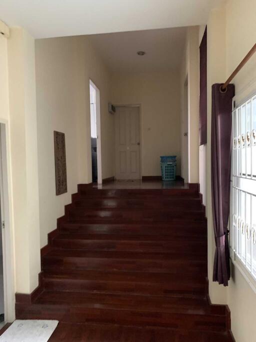 Interior hallway with dark wooden staircase