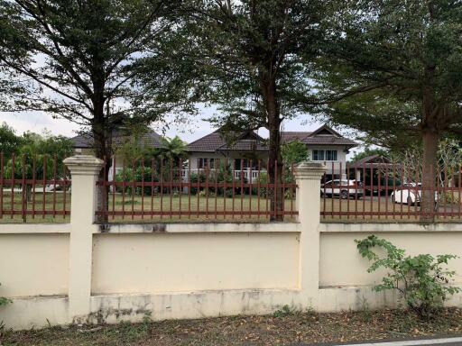 Exterior view of a house with front yard and trees