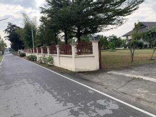 Exterior view of property with front yard and trees