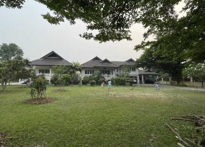 Front view of a large house with garden