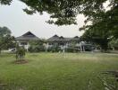 Front view of a large house with garden