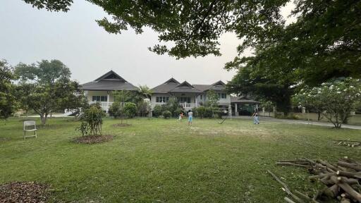 Front view of a large house with garden