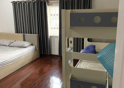 Bedroom with double bed, bunk bed, and wooden flooring