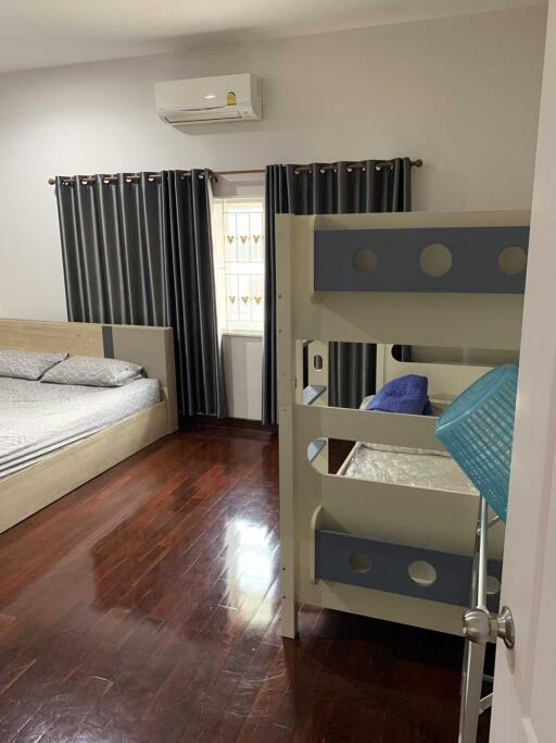 Bedroom with double bed, bunk bed, and wooden flooring