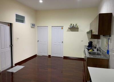 Modern kitchen with wooden floors and white doors