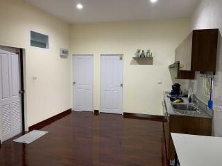 Modern kitchen with wooden floors and white doors