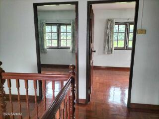 Upper floor hallway with view into two bedrooms