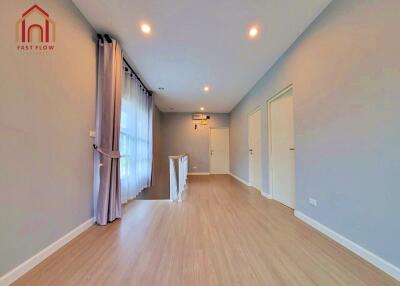 spacious main living area with wooden floors and large windows