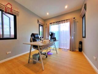 Modern home office with desk, chair, and large windows