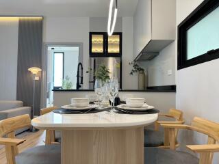 Modern kitchen with dining area, stylish lighting, and contemporary decor