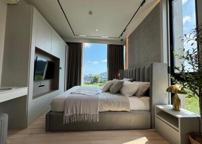 Modern bedroom with large windows and scenic view