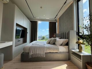 Modern bedroom with large windows and scenic view