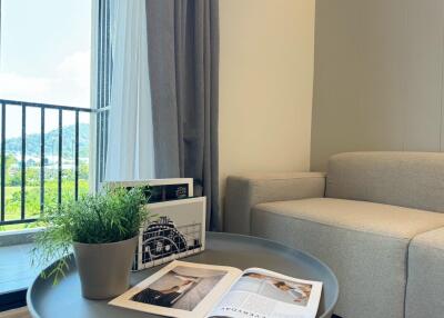 Cozy living room with a grey couch and coffee table by the window