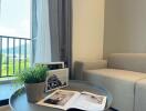 Cozy living room with a grey couch and coffee table by the window