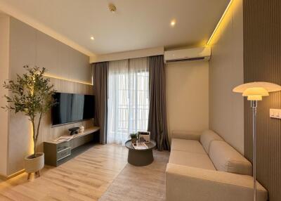 Modern living room with beige sofa and wall-mounted TV