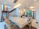 Modern kitchen and dining area with stairs and large windows